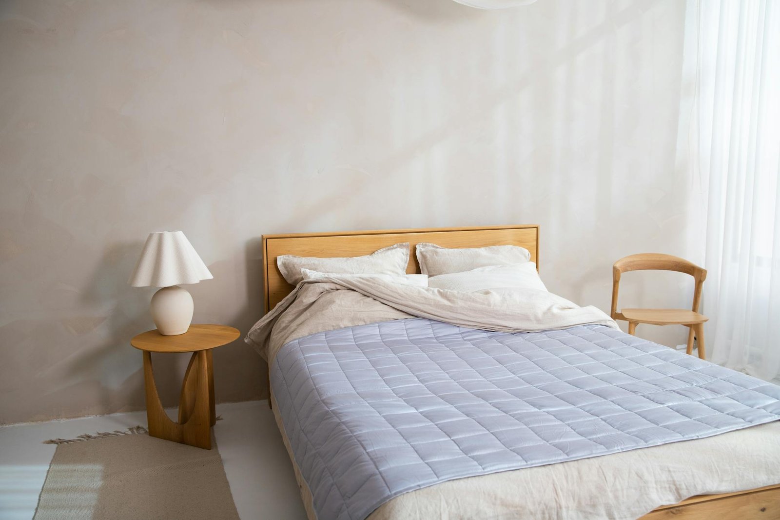 Contemporary bedroom design with wooden furniture and soft natural lighting.